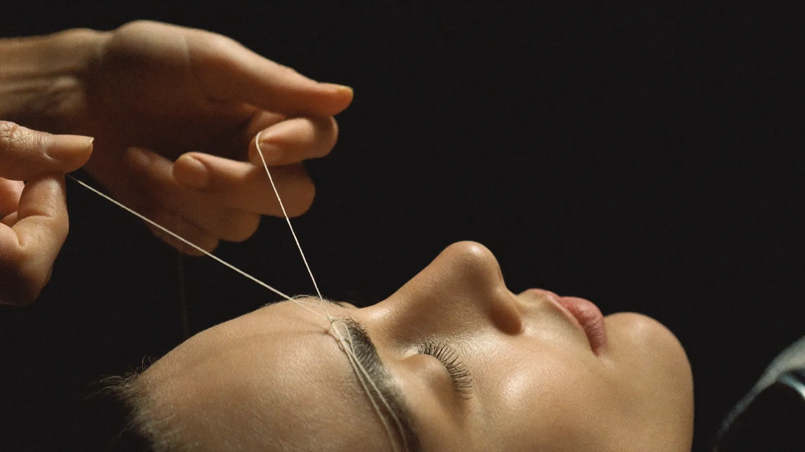 Eyebrow threading in progress